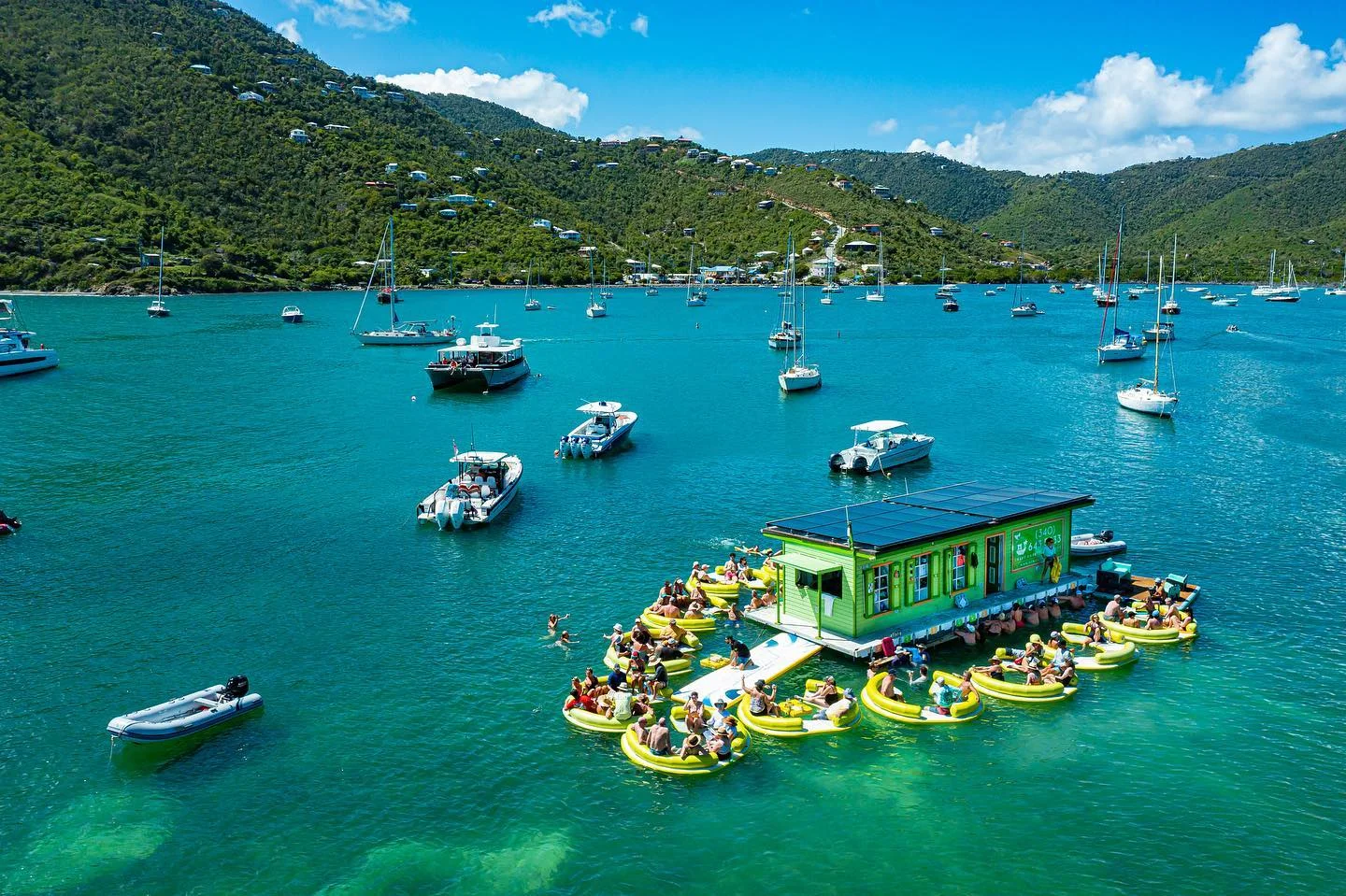 Aerial view of the Lime Out floating taco bar surrounded by guests on floats