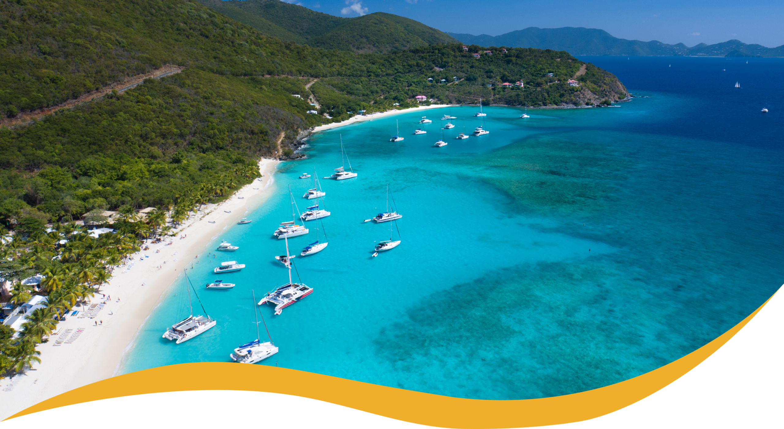 Charter Smarter crewed yacht charters in the Virgin Islands, aerial view of a turquoise bay with anchored yachts